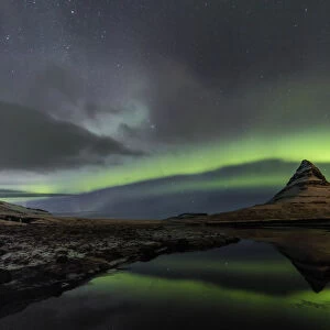 Aurora borealis reflects below Kirkjufell aka Church Mountain on the Snaefellsnes