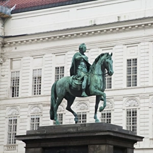 Austria, Vienna. Low angle view of a statue of a man on a horse. The statue is situated