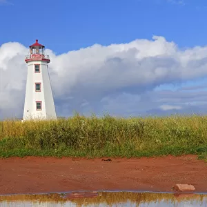 Canada, Prince Edward Island, North Cape. North Point Lighthouse reflects in pool