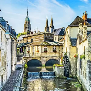 Colorful old buildings, Aure River reflection, Bayeux, Normandy, France. Bayeux founded 1st century BC, first city liberated after D-Day