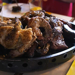 A dish of typical Uruguay barbecue with chicken, pork, beef, sausages, sweetbread