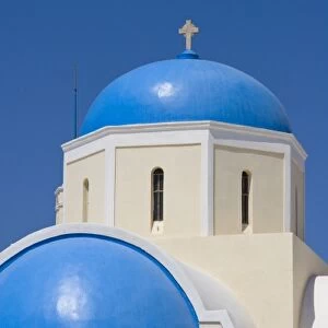 Greece, Santorini, Thira, Oia. Blue Greek Orthodox church domes against blue sky