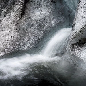 Iceland, abstract ice, ash and meltwater flume on the Solheimajokull Glacier