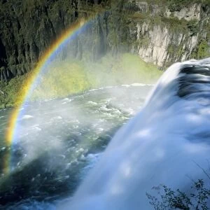 Idaho. USA. Rainbow in spray above Upper Mesa Falls on Henrys Fork of Snake River