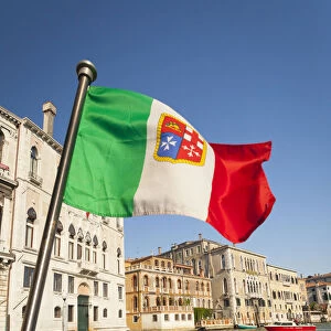 Italy, Venice, Italian flag with Naval ensign flying above Grand Canal