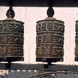 Nepal, Kathmandu. Buddhist prayer wheels at Swayambhunath Monkey Temple