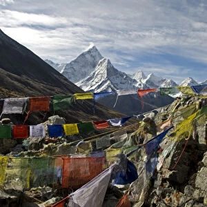 Nepal. Prayer flags are hung along the Everest Base Camp Trail with the peak of Ama