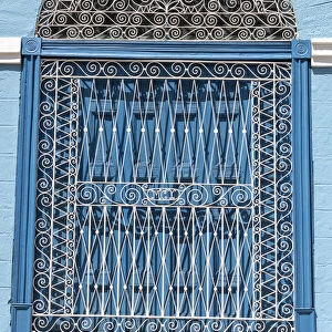 Ornate wrought iron covering on blue wooden window shutters, Trinidad, Cuba