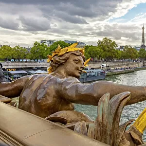 Paris. Nymphes de la Seine statue on Pont Alexandre III, along River Seine. Distant Eiffel Tower