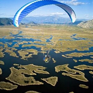 Powered paraglider flying over Dalyan, aerial view, Koycegiz, Mugla, Turkey