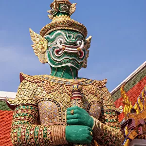 Thailand, Bangkok. Yaksha, demon depicted in the Ramayana, guarding Wat Phra Kaew (Temple of The Emerald Buddha)
