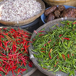 Thailand, Chiang Mai. Thai street vendor of green and red Chilis