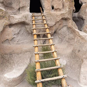 USA, New Mexico. Bandelier National Monument, Ladder leads to entrance in dwelling carved