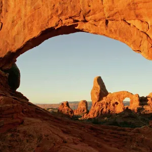 USA, Utah, Arches National Park. Turret arch seen through the North Window at sunrise