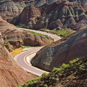 A winding road through the colorful mountains in Zhangye National Geopark