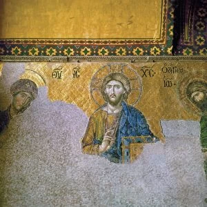 The 13th century Deesis mosaic in the South Gallery of the Hagia Sophia in Istanbul, Turkey, depicting Jesus Christ, the Virgin Mary and John the Baptist. Photograph, 20th century