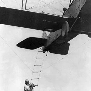 AIRPLANE STUNT MAN, 1921. Fearless Freddie, a Hollywood stunt man, clinging to