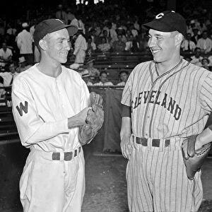 BASEBALL, 1937. Bucky Jacobs of the Washington Senators and Bob Feller of the Cleveland