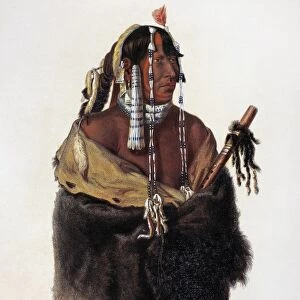 BODMER: YOUNG MANDAN. Mandeh-Pahchu, a young Mandan Native American man, holding a peace pipe. Aquatint engraving, c1844, after a drawing, c1833, by Karl Bodmer