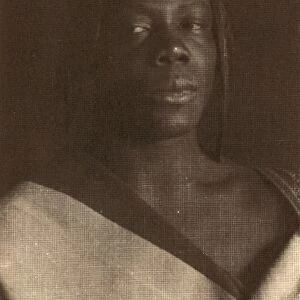 DAY: MAN, c1896. Portrait of a young man wearing an African costume