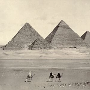 EGYPT: PYRAMIDS AT GIZA. The pyramids at Giza, Egypt, with three travelers in the foreground. Photograph, late 19th century
