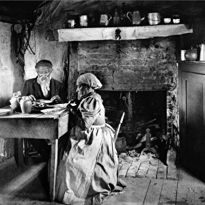 An elderly African American couple in their rural Virginia home, having a meal together. Photographed by Francis Benjamin Johnston, c1899