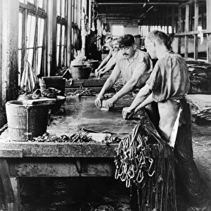 LEATHER MANUFACTURE, c1918. Workers scraping hides at the Alexander Brothers Leather
