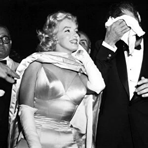 MARILYN MONROE (1926-1962). American cinema actress. Photographed with her husband, playwright Arthur Miller, at the premiere of the film, The Prince and the Showgirl, at Radio City Music Hall in New York City, 13 June 1957