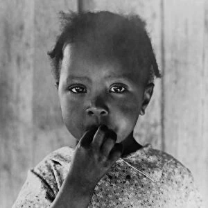 MIGRANT CHILD, 1937. An African American child of a former sharecropper that works