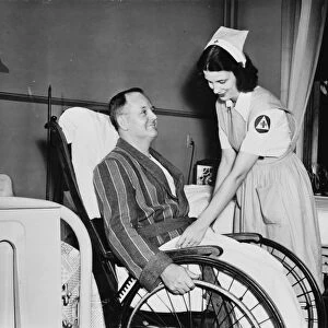 RED CROSS, c1942. A Red Cross nurses aid with a patient in an American hospital