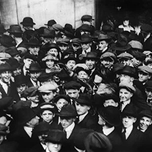 STOCK BROKERS, 1920. Crowd of men involved in curb exchange trading on Wall Street, New York City