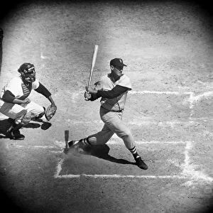 TED WILLIAMS (1918-2002). Theodore Samuel Williams. American baseball player. Batting against the New York Yankees as a member of the Boston Red Sox during a spring training exhibition game in St. Petersburg, Florida, while Yankees catcher Elston Howard watches from behind home plate, c1957