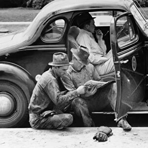 TEXAS: OIL WORKERS, 1939. Oil field workers reading the newspaper during a break at Kilgore