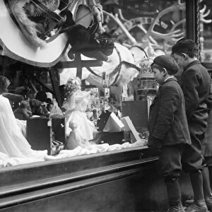 WINDOW DISPLAY, c1910. Boys looking at Christmas toys in a shop window. Photograph