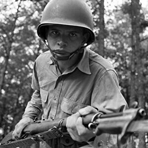 WORLD WAR II: SERGEANT, 1942. Sergeant George Camblair learning to use a bayonet while training at Fort Belvoir, Virginia. Photograph by Jack Delano, September 1942