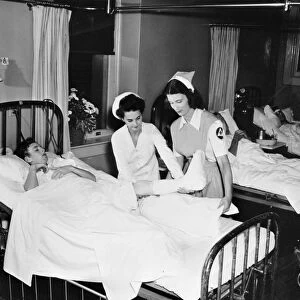 WW II: CIVILIAN HOSPITAL. Red Cross nurses aids working in an American hospital