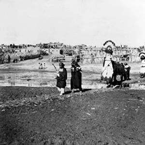 ZUNI: SHALAKO DANCERS, c1898. Procession of Zuni Shalako dancers at a pueblo village