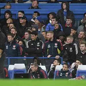 Arsenal Manager Mikel Arteta Discusses Tactics with Assistant Coach Albert Stuivenberg during Chelsea vs Arsenal (2022-23)