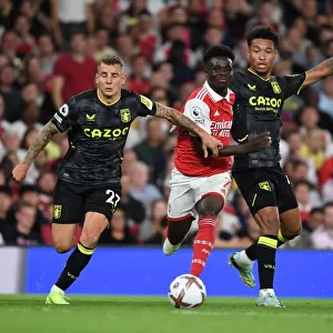 Arsenal's Bukayo Saka Faces Off Against Aston Villa's Lucas Digne and Boubacar Bernard Kamara in 2022-23 Premier League Clash