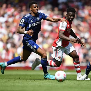 Arsenal's Bukayo Saka Outmaneuvers Leeds Junior Firpo in Premier League Clash