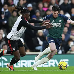 Arsenal's Declan Rice Fends Off Fulham's Calvin Bassey in Premier League Clash (Fulham v Arsenal 2023-24)