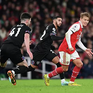 Arsenal's Odegaard Faces Pressure from West Ham's Benrahma in Premier League Clash
