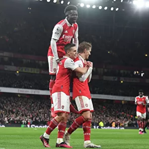 Arsenal's Triumph: Odegaard, Trossard, and Saka Celebrate 3rd Goal vs. Everton (2022-23)