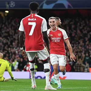 Arsenal's Trossard and Saka Celebrate First Goal vs Sevilla in 2023-24 Champions League