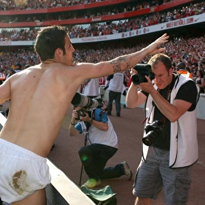 Cesc Fabregas (Arsenal) throws his shrt to the fans after the match