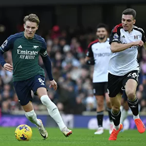 Clash at Craven Cottage: Arsenal's Martin Odegaard Fends Off Fulham's Joao Palhinha