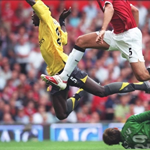 Emmanuel Adebayor is tripped by Manchester United goalkeeper Tomaz Kuszczak for the Arsenal penalty