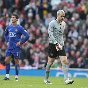 Injured Arsenal goalkeeper Manuel Almunia leaves the field
