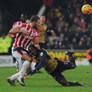 Intense Face-off: Joel Campbell vs. Erik Pieters in Arsenal's Premier League Battle