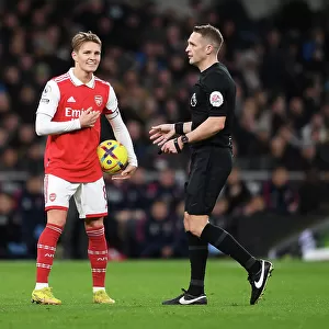 Martin Odegaard and Referee Craig Pawson in Action: Tottenham vs. Arsenal, Premier League 2022-23